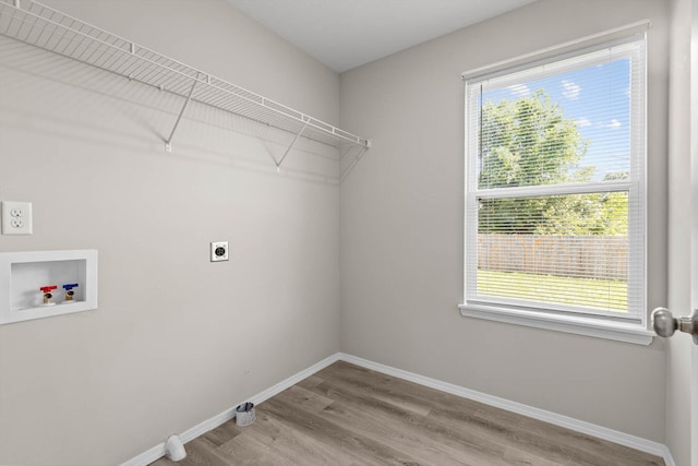 200 E Rosalie St, Strafford, MO 65757 - laundry room featuring hookup for a washing machine, hookup for an electric dryer, healthy amount of natural light, and wood finished floors