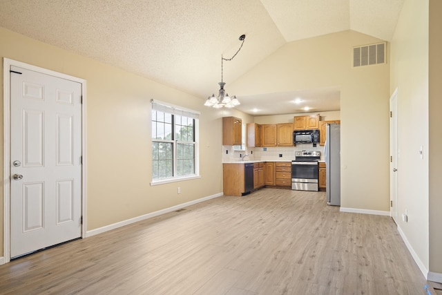 1813 Boswell Ave, Branson, MO 65616 - kitchen with black appliances, a chandelier, light countertops, light wood-style floors, and vaulted ceiling
