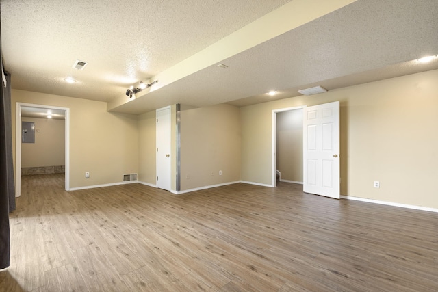 1813 Boswell Ave, Branson, MO 65616 - unfurnished room with a textured ceiling, electric panel, and wood finished floors