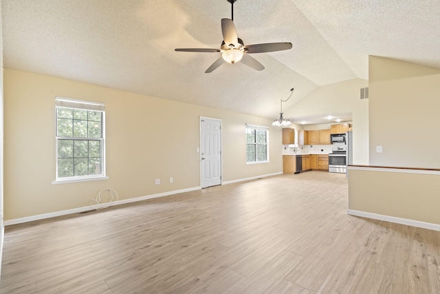 1813 Boswell Ave, Branson, MO 65616 - unfurnished living room featuring a ceiling fan, a textured ceiling, light wood-style floors, healthy amount of natural light, and lofted ceiling