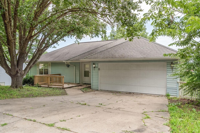 1813 Boswell Ave, Branson, MO 65616 - ranch-style home with a shingled roof, an attached garage, and driveway