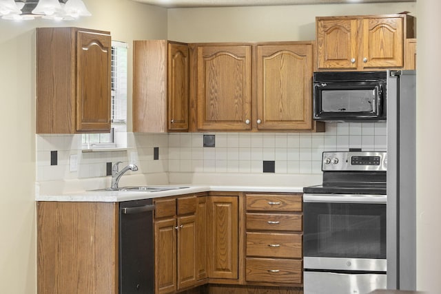 1813 Boswell Ave, Branson, MO 65616 - kitchen with stainless steel appliances, tasteful backsplash, light countertops, and brown cabinetry