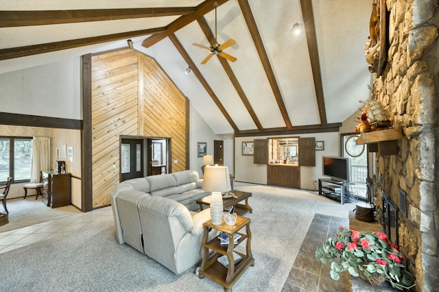 636 Crader Ct, Springfield, MO 65802 - living room featuring high vaulted ceiling, plenty of natural light, beamed ceiling, carpet floors, and wood walls