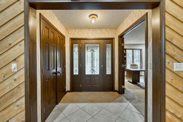 636 Crader Ct, Springfield, MO 65802 - foyer with a textured ceiling, light tile patterned floors, and light colored carpet