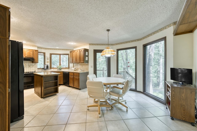 636 Crader Ct, Springfield, MO 65802 - kitchen with black appliances, a textured ceiling, backsplash, light countertops, and brown cabinetry