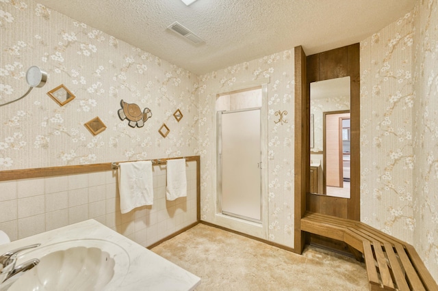 636 Crader Ct, Springfield, MO 65802 - full bathroom featuring wallpapered walls, a shower stall, vanity, and a textured ceiling