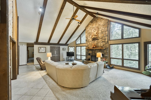 636 Crader Ct, Springfield, MO 65802 - living area featuring high vaulted ceiling, light tile patterned floors, beam ceiling, a textured ceiling, and a stone fireplace