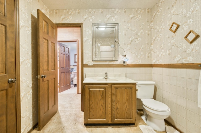 636 Crader Ct, Springfield, MO 65802 - half bath featuring wallpapered walls, vanity, wainscoting, and tile walls