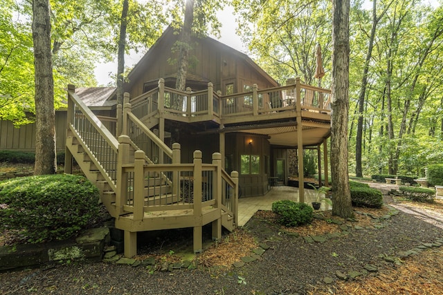 636 Crader Ct, Springfield, MO 65802 - rear view of house featuring a wooden deck, board and batten siding, and a patio area