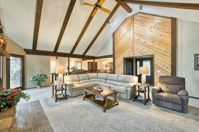 636 Crader Ct, Springfield, MO 65802 - carpeted living room featuring high vaulted ceiling, wood walls, beam ceiling, and ceiling fan