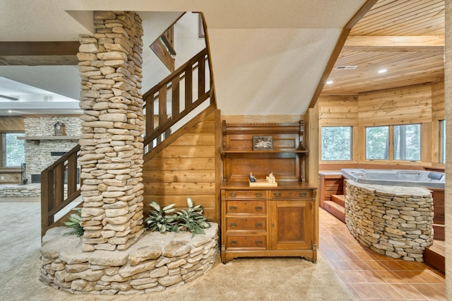 636 Crader Ct, Springfield, MO 65802 - staircase with healthy amount of natural light, recessed lighting, a stone fireplace, wooden walls, and carpet flooring