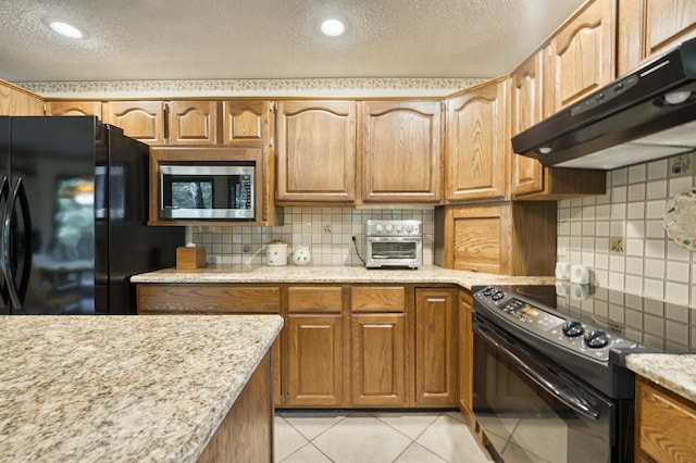 636 Crader Ct, Springfield, MO 65802 - kitchen featuring black appliances, under cabinet range hood, a textured ceiling, decorative backsplash, and light tile patterned flooring