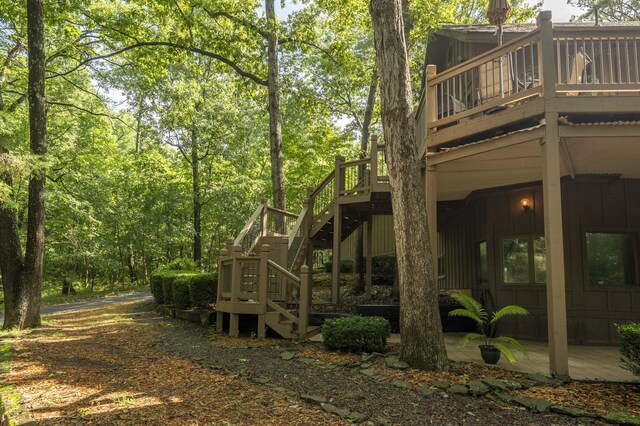 636 Crader Ct, Springfield, MO 65802 - rear view of house with stairway and a wooden deck