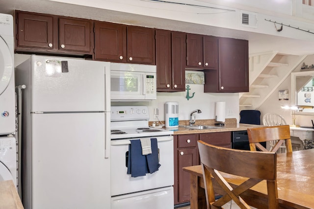 440 Fall Creek Dr Unit 7, Branson, MO 65616 - kitchen with white appliances, stacked washer / dryer, and light countertops