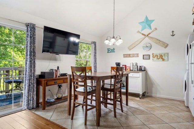 440 Fall Creek Dr Unit 7, Branson, MO 65616 - dining space featuring vaulted ceiling, a chandelier, stacked washer and clothes dryer, and light tile patterned floors