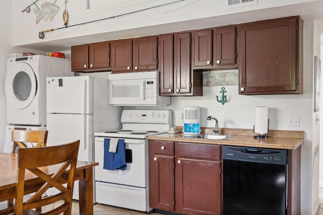 440 Fall Creek Dr Unit 7, Branson, MO 65616 - kitchen featuring white appliances, stacked washing machine and dryer, and light countertops