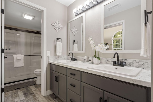 530 Abby Ln Unit 5, Branson, MO 65616 - full bathroom featuring double vanity, wood finished floors, a stall shower, and tasteful backsplash