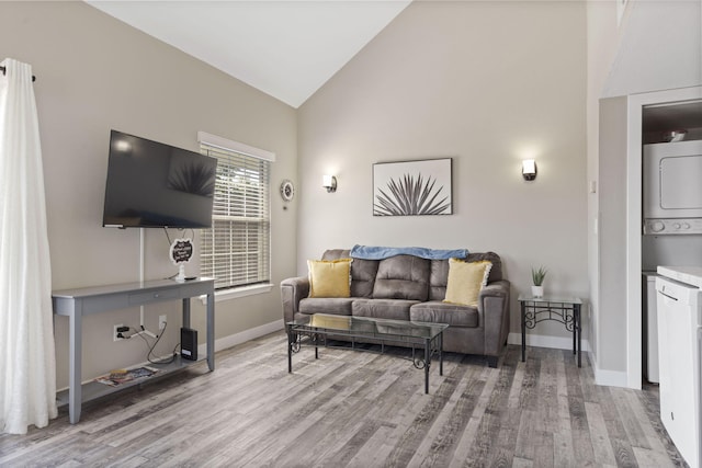 530 Abby Ln Unit 5, Branson, MO 65616 - living room featuring stacked washer and clothes dryer, light wood finished floors, and high vaulted ceiling