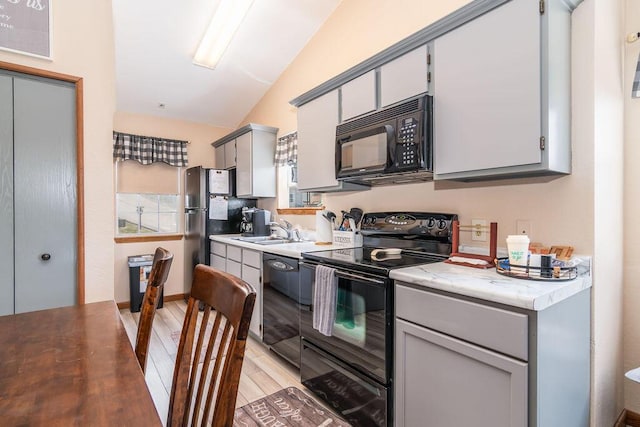 27 Blue Bird Way Unit 5, Branson, MO 65616 - kitchen featuring black appliances, vaulted ceiling, light wood-type flooring, and gray cabinetry
