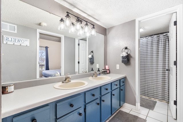 1 Memory Ln Unit 5, Branson, MO 65616 - ensuite bathroom with double vanity, a textured ceiling, tile patterned floors, and a textured wall