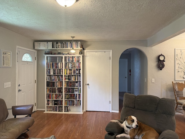 2304 E Huntington St, Ozark, MO 65721 - living area with arched walkways, a textured ceiling, and wood finished floors