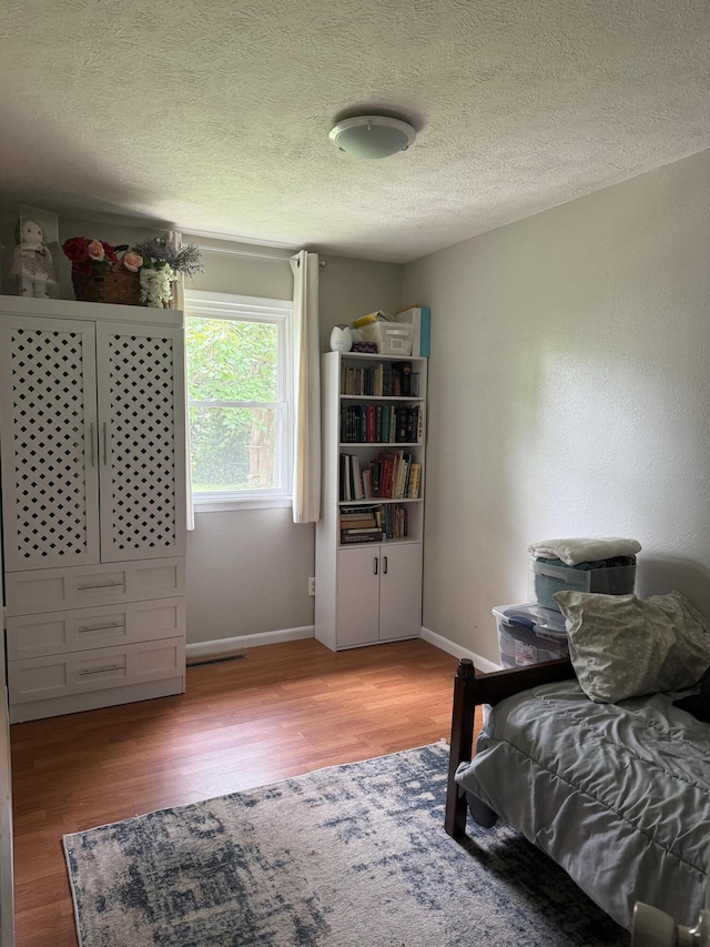2304 E Huntington St, Ozark, MO 65721 - bedroom with light wood-style floors and a textured ceiling