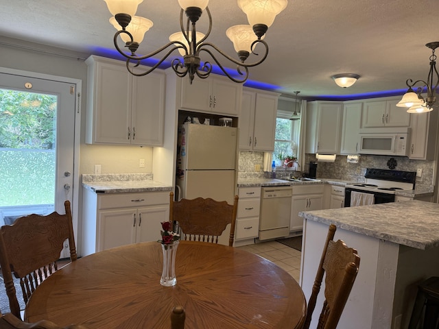 2304 E Huntington St, Ozark, MO 65721 - kitchen with white appliances, a chandelier, backsplash, light tile patterned floors, and light countertops