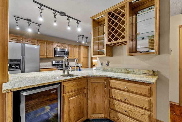 641 N Park Pl, Bolivar, MO 65613 - kitchen with wine cooler, appliances with stainless steel finishes, light stone countertops, brown cabinets, and a peninsula