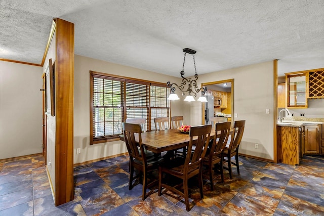641 N Park Pl, Bolivar, MO 65613 - dining space with a textured ceiling, a chandelier, and dark stone finish flooring