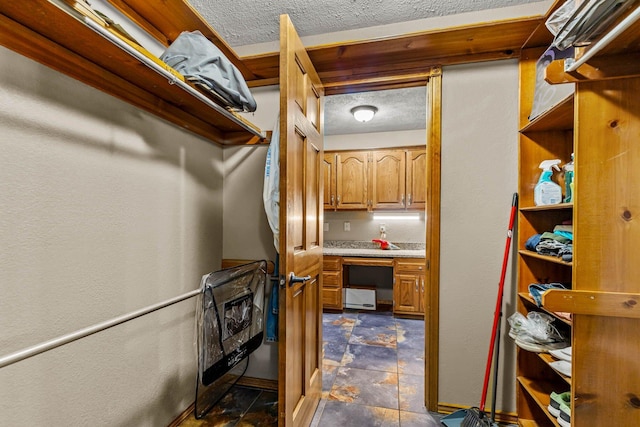 641 N Park Pl, Bolivar, MO 65613 - walk in closet with dark stone finish floors and heating unit