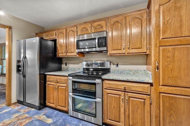 641 N Park Pl, Bolivar, MO 65613 - kitchen featuring appliances with stainless steel finishes and brown cabinetry