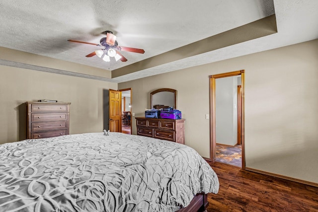 641 N Park Pl, Bolivar, MO 65613 - bedroom with dark wood-style floors, a textured ceiling, and a ceiling fan