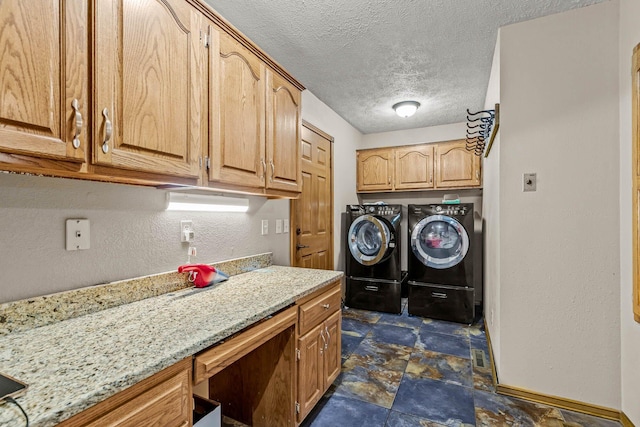 641 N Park Pl, Bolivar, MO 65613 - laundry room with cabinet space, washer and dryer, a textured ceiling, and a textured wall