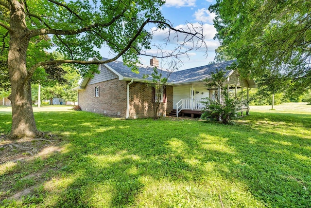 641 N Park Pl, Bolivar, MO 65613 - view of property exterior with covered porch, brick siding, a yard, and a chimney