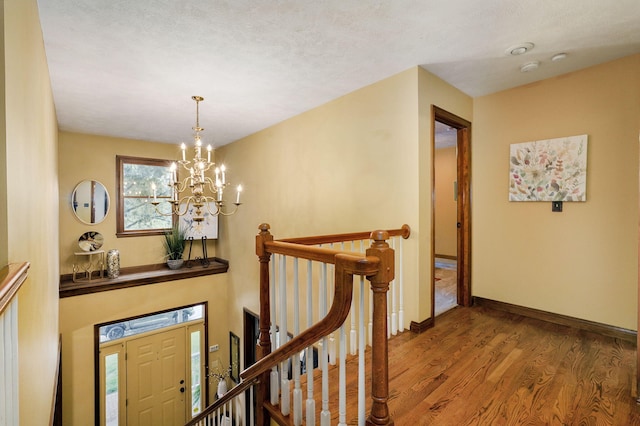 3449 S Woodstock Dr, Springfield, MO 65809 - hall with an upstairs landing, a chandelier, and wood finished floors