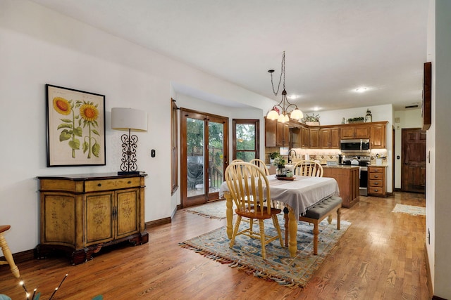 3449 S Woodstock Dr, Springfield, MO 65809 - dining area featuring light wood-style flooring and baseboards