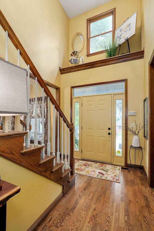 3449 S Woodstock Dr, Springfield, MO 65809 - foyer with a towering ceiling, stairway, and wood finished floors