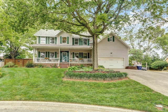 3449 S Woodstock Dr, Springfield, MO 65809 - view of front of house with concrete driveway, a garage, and covered porch