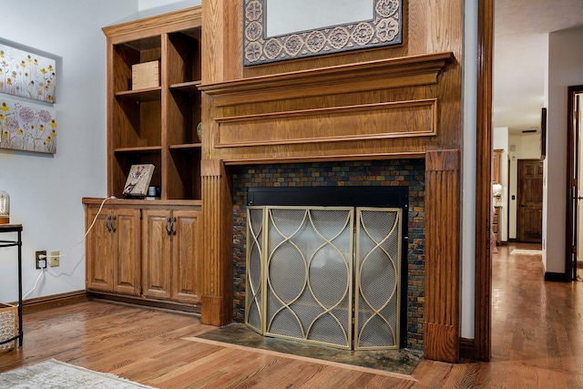 3449 S Woodstock Dr, Springfield, MO 65809 - detailed view of wood finished floors and a fireplace with flush hearth