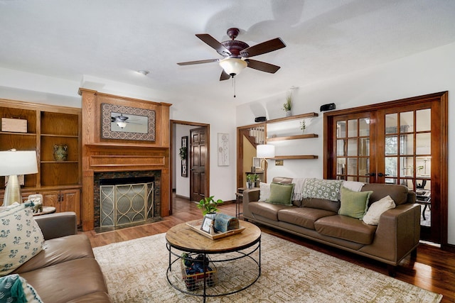 3449 S Woodstock Dr, Springfield, MO 65809 - living area featuring a ceiling fan, wood finished floors, french doors, and a fireplace with flush hearth