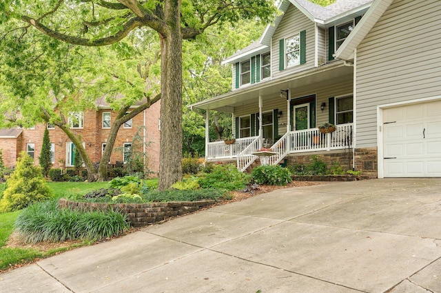 3449 S Woodstock Dr, Springfield, MO 65809 - view of front of property featuring a porch and concrete driveway