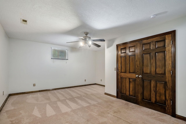 3449 S Woodstock Dr, Springfield, MO 65809 - unfurnished bedroom featuring light colored carpet, a textured ceiling, and a ceiling fan