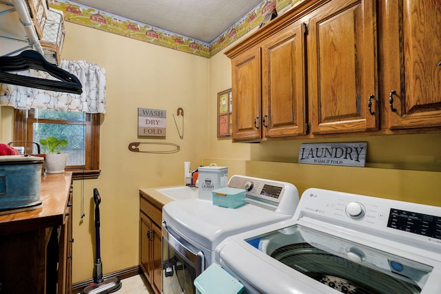 3449 S Woodstock Dr, Springfield, MO 65809 - laundry room with washing machine and clothes dryer, cabinet space, and a textured ceiling