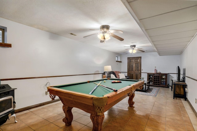 3449 S Woodstock Dr, Springfield, MO 65809 - game room with ceiling fan, pool table, light tile patterned floors, and a wood stove