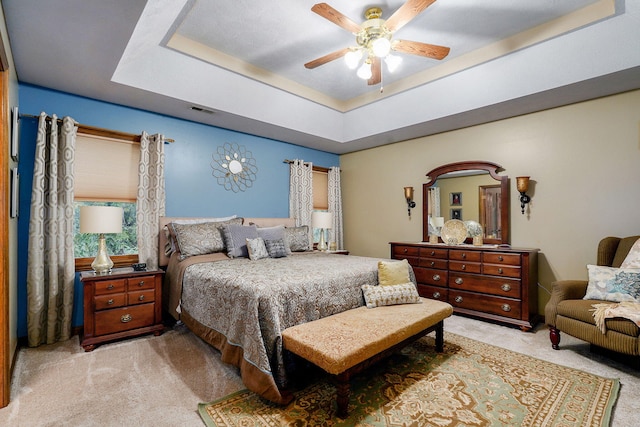 3449 S Woodstock Dr, Springfield, MO 65809 - bedroom featuring light colored carpet, a tray ceiling, and ceiling fan