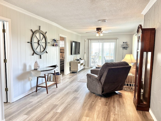 25419 County Road 327, Urbana, MO 65767 - living room with crown molding, light wood-style floors, a textured ceiling, and a ceiling fan
