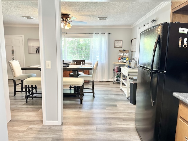 25419 County Road 327, Urbana, MO 65767 - dining room with a textured ceiling, a ceiling fan, crown molding, and light wood-style floors