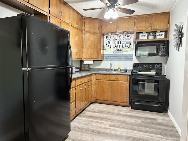 25419 County Road 327, Urbana, MO 65767 - kitchen featuring black appliances, brown cabinets, a ceiling fan, light wood-style flooring, and a textured ceiling