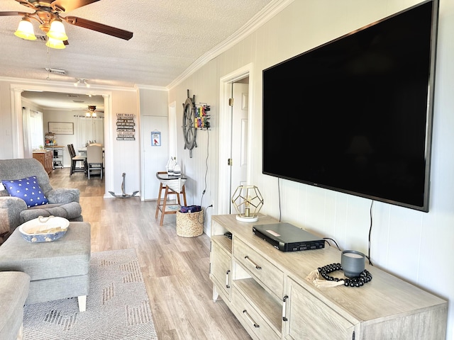 25419 County Road 327, Urbana, MO 65767 - living area featuring ceiling fan, ornamental molding, light wood finished floors, and a textured ceiling