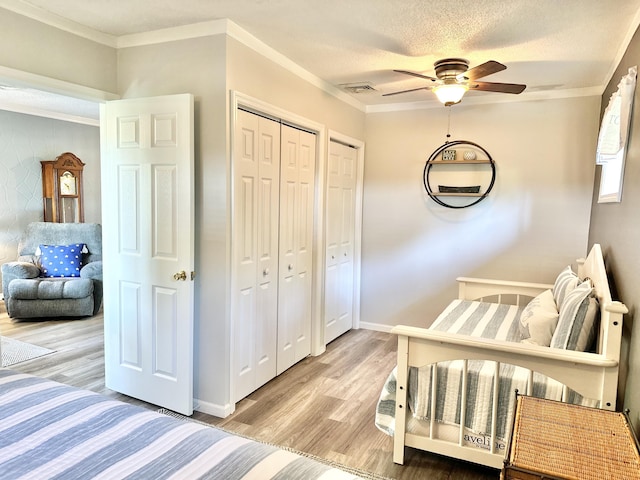 25419 County Road 327, Urbana, MO 65767 - bedroom featuring wood finished floors, crown molding, a ceiling fan, and a textured ceiling